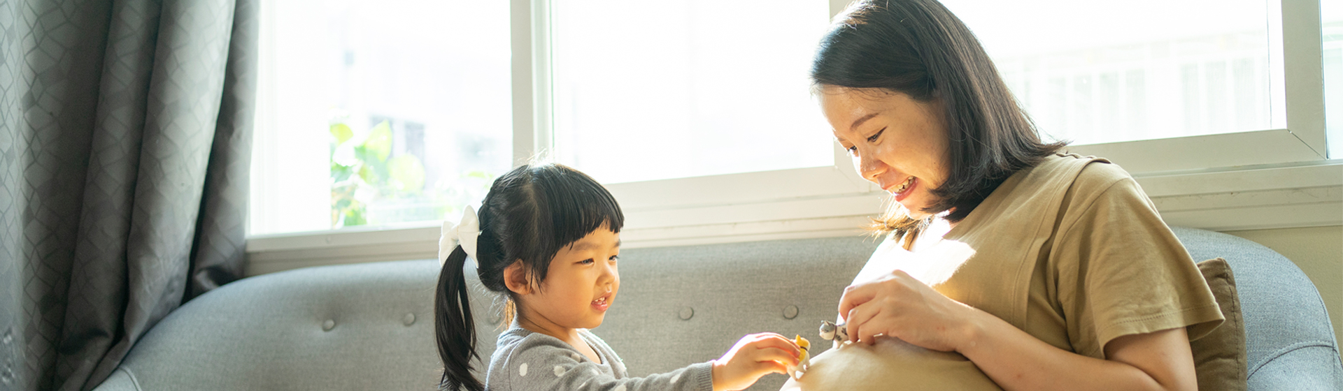 Pregnant Asian Mother with Daughter