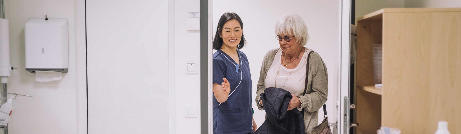 Nurse guiding patient into room