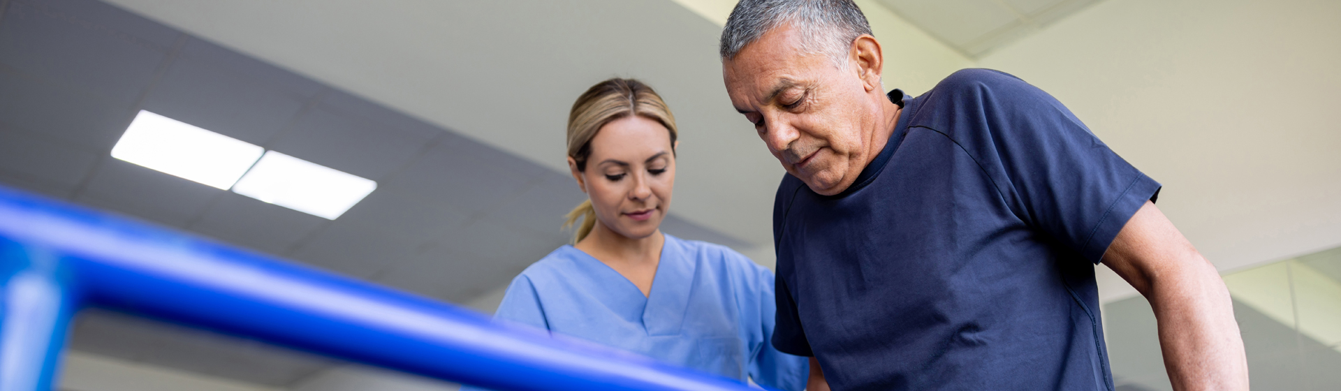 Man doing physical therapy and walking on bars