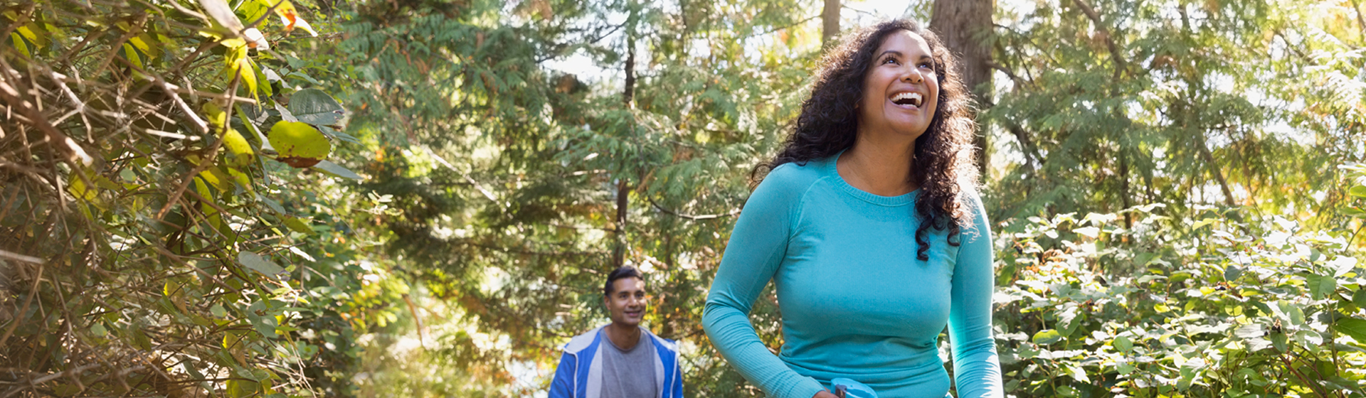 Two people hike in the woods