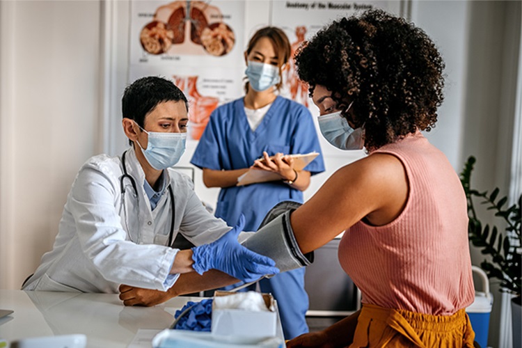 Primary care doctor checking a patient's blood pressure