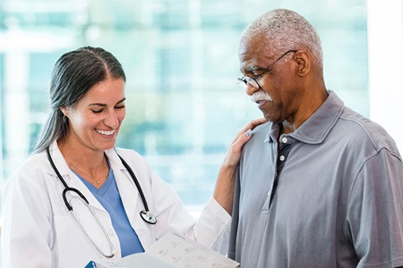 Female doctor talking with male patient